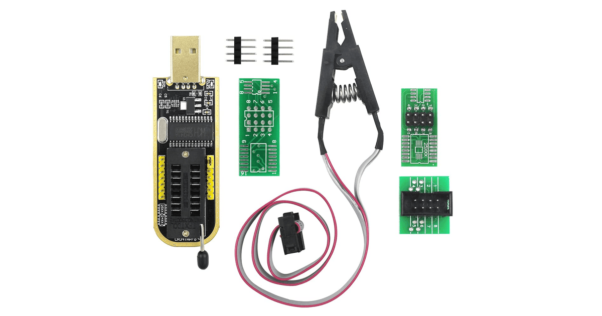 A CH341A SPI flash programmer kit with its SOIC test clip, ribbon cable, header pins and adapter boards